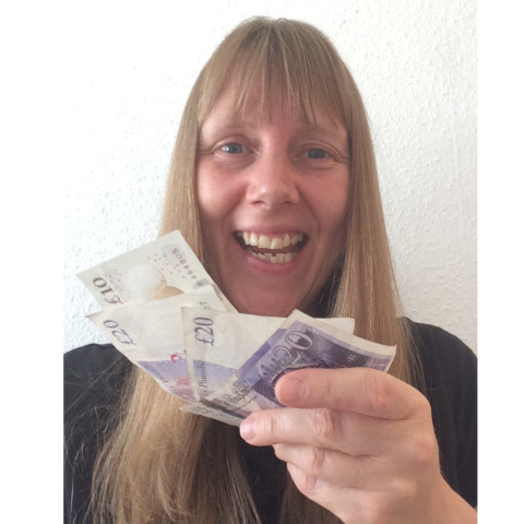 Sandra Bellamy Holding Money And Smiling